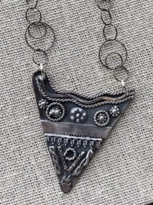 Triangular Sterling silver necklace with surface decorations