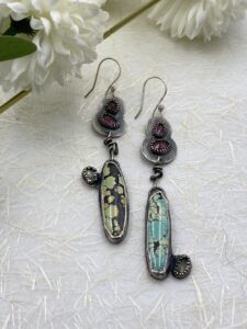 Sterling silver earring featuring oblong turquoise stones in blue/green/black and three rainbow tourmalines each