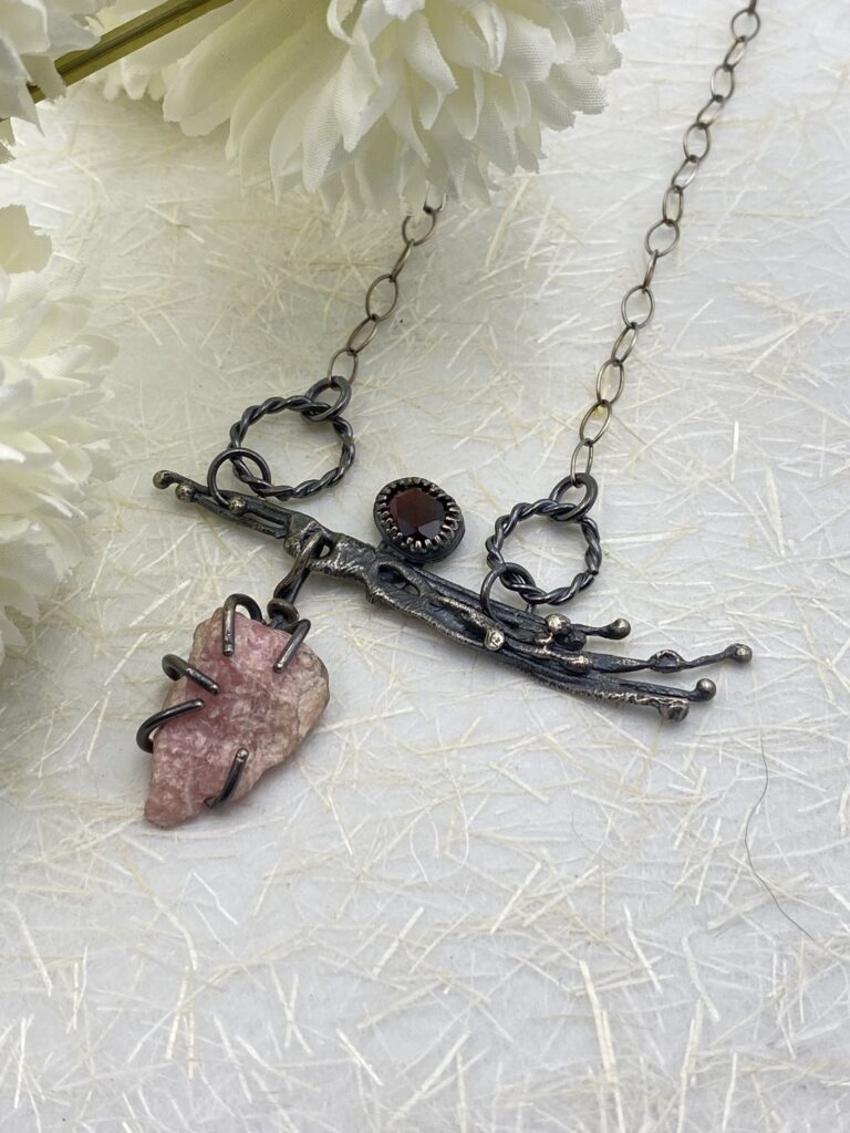 Sterling silver branches with hessonite gem above and raw pink rhodochrosite stone below. Sterling silver chain.