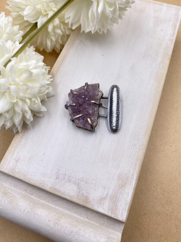 Sterling silver brooch with a purple amethyst druzy on the left side and a shiny white stick pearl on the right side