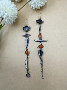 Long, multi-component earrings with Sterling silver, carnelians, stick pearls, and bronze accents